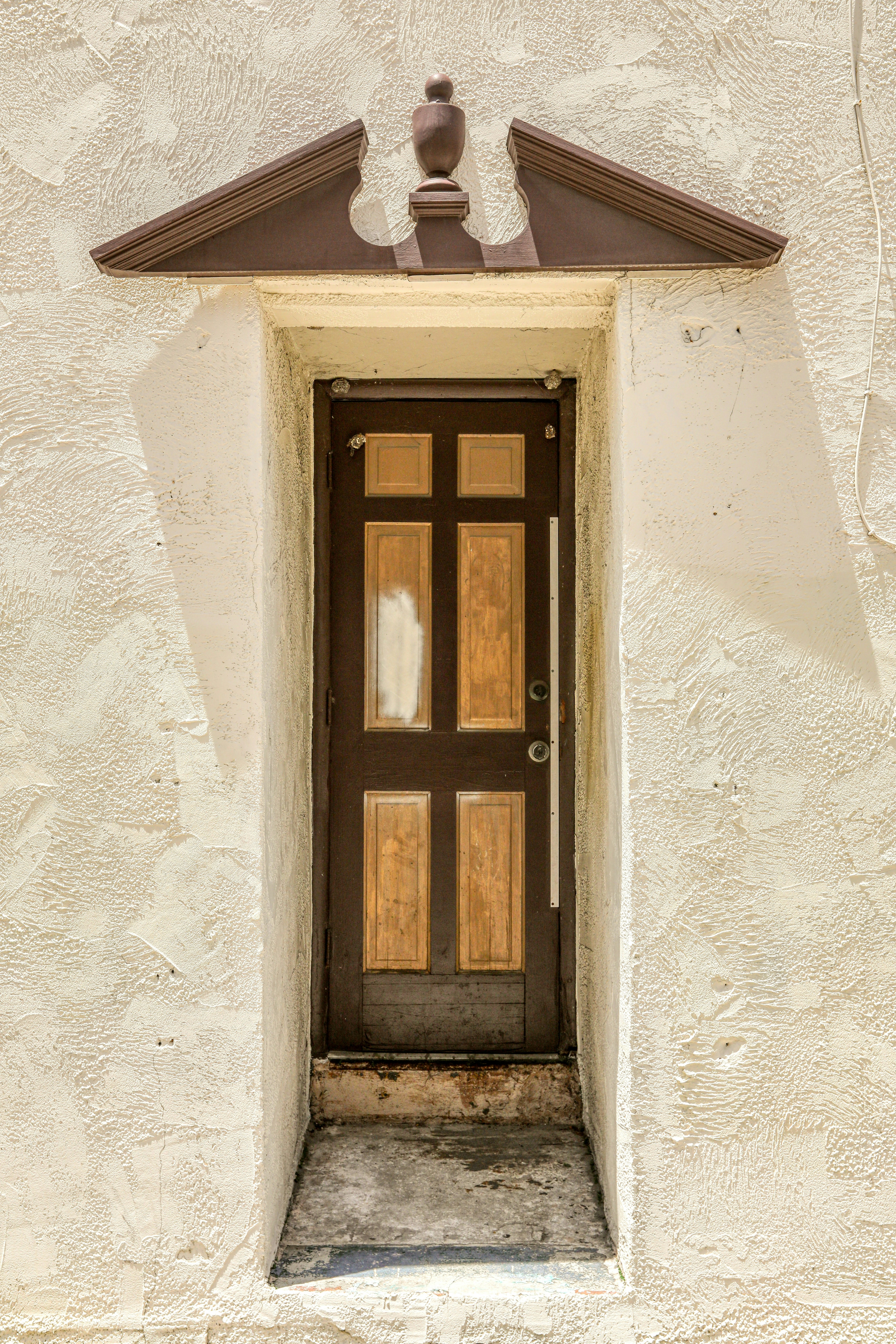 brown wooden window on white concrete wall